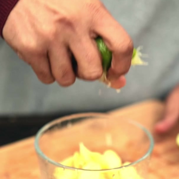 Half a lime squeezed by hand over a glass bowl of thinly sliced fresh ginger, Vaidya Jay's three ingredient digestive hack