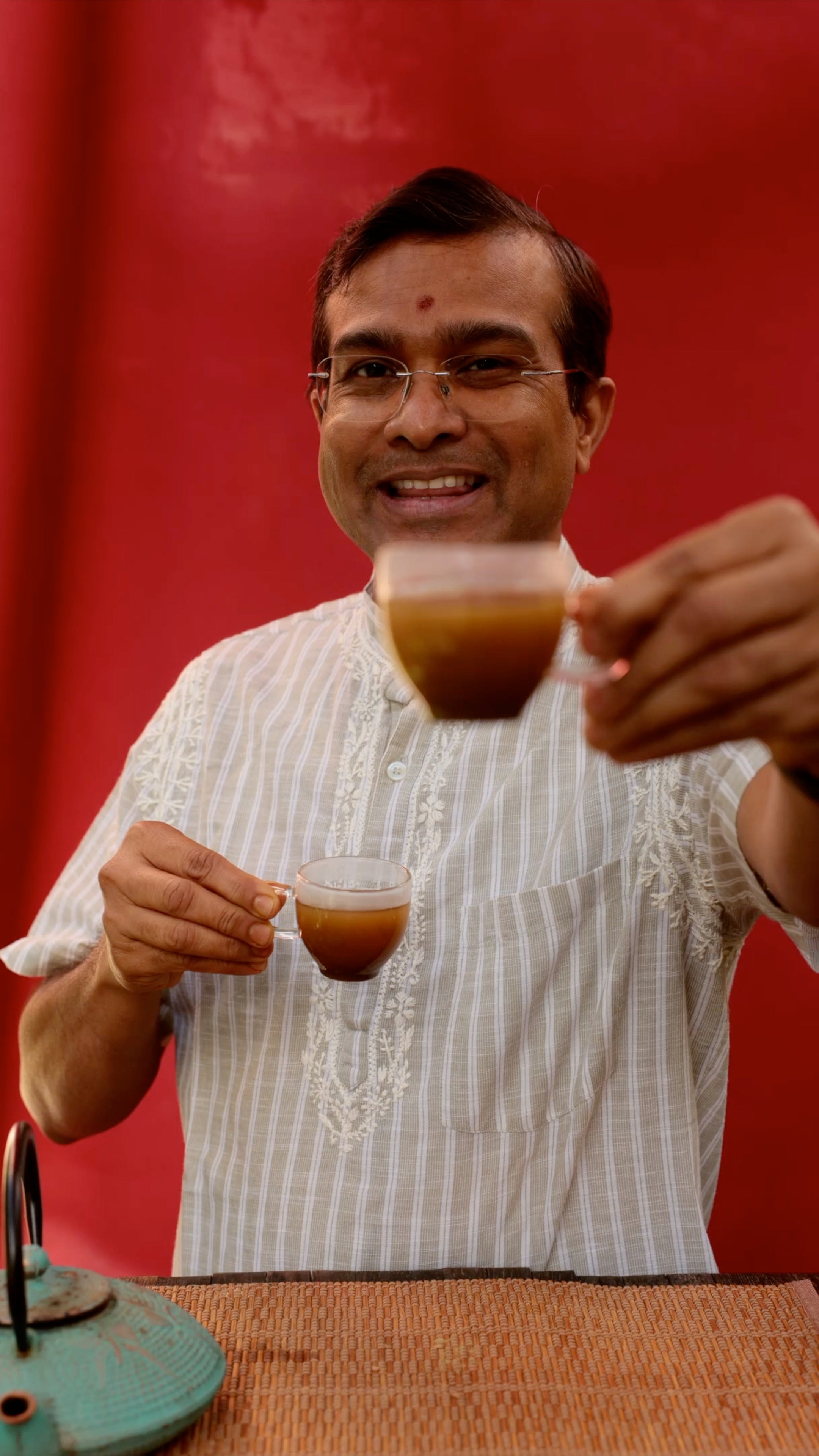 Vaidya Jay raising two cups of the spring tea